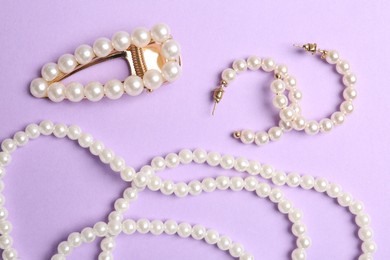 Photo of Stylish accessories on lilac background, flat lay