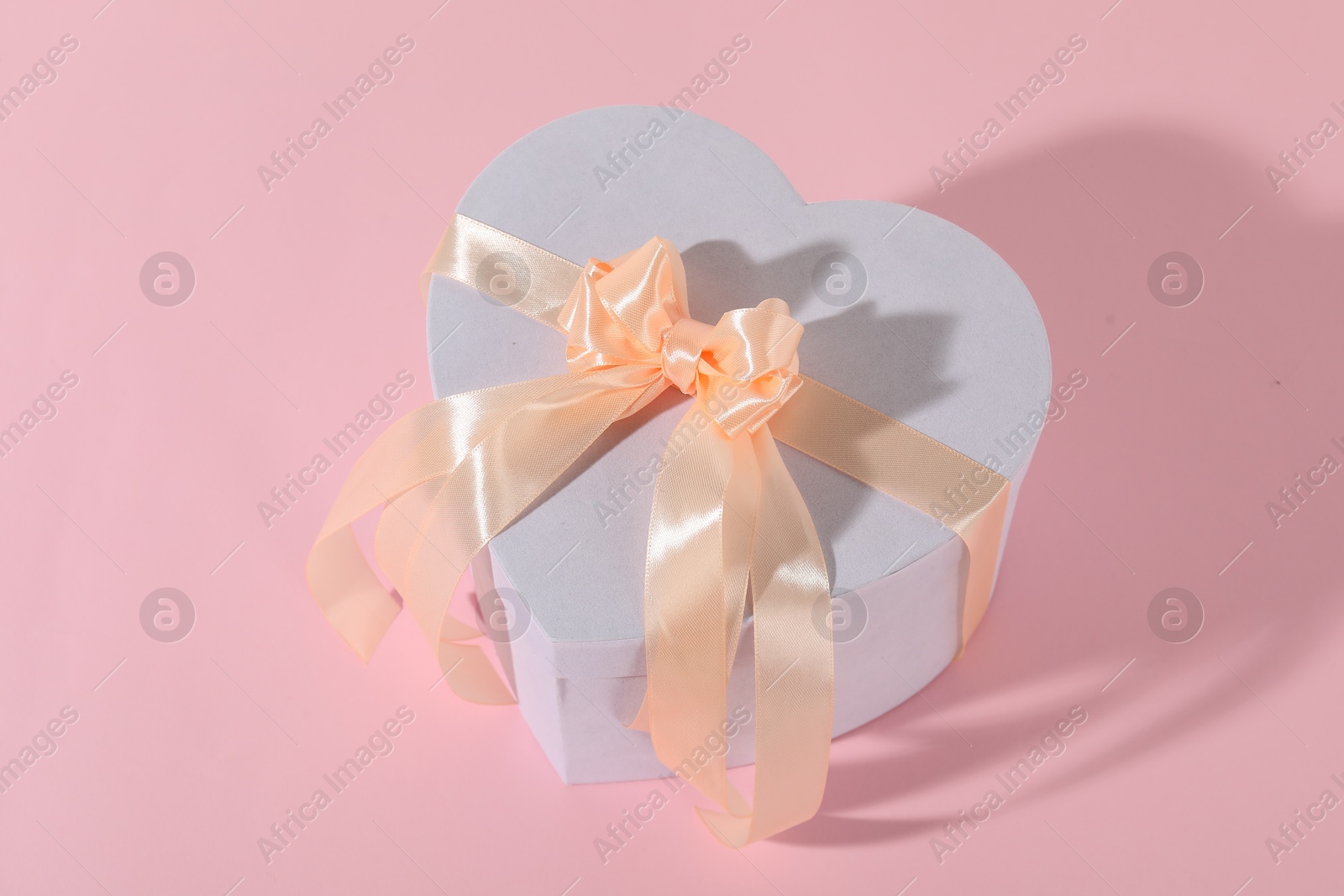 Photo of One beautiful wedding gift on pink background