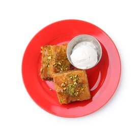 Photo of Tasty baklava with chopped nuts and scoop of ice cream isolated on white, top view