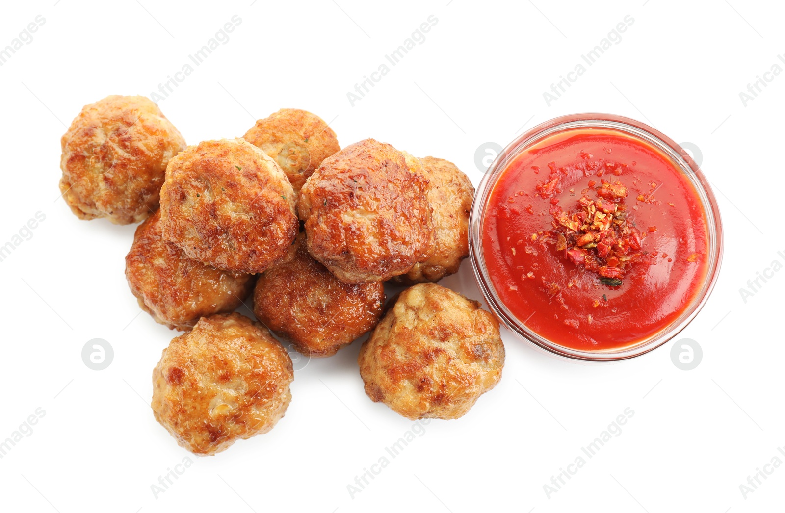 Photo of Pile of delicious meatballs and bowl with ketchup isolated on white, top view