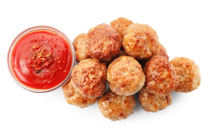 Photo of Pile of delicious meatballs and bowl with ketchup isolated on white, top view