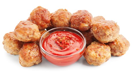 Photo of Pile of delicious meatballs and bowl with ketchup isolated on white