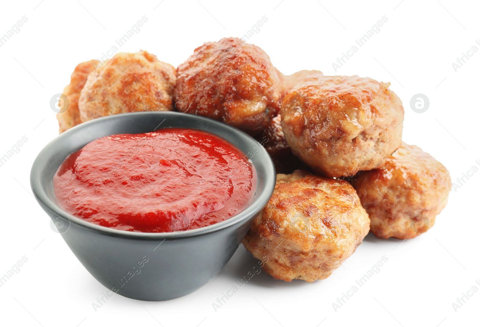 Photo of Pile of delicious meatballs and bowl with ketchup isolated on white