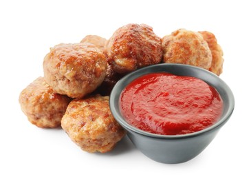 Photo of Pile of delicious meatballs and bowl with ketchup isolated on white