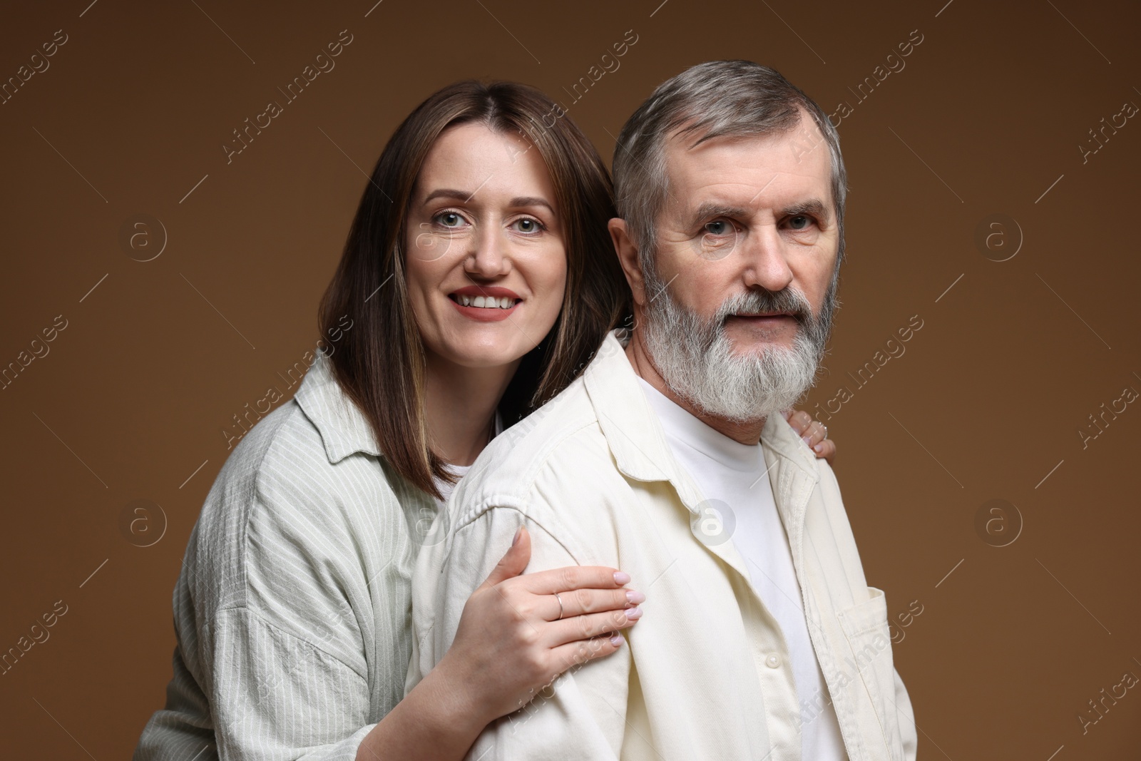 Photo of Family portrait of happy daughter and her father on brown background