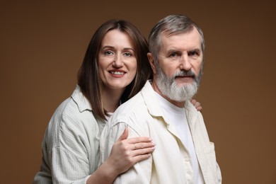 Photo of Family portrait of happy daughter and her father on brown background