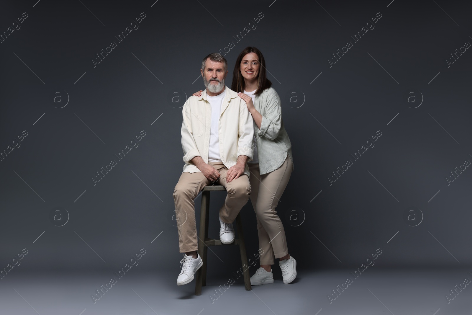 Photo of Happy daughter and her father on dark background