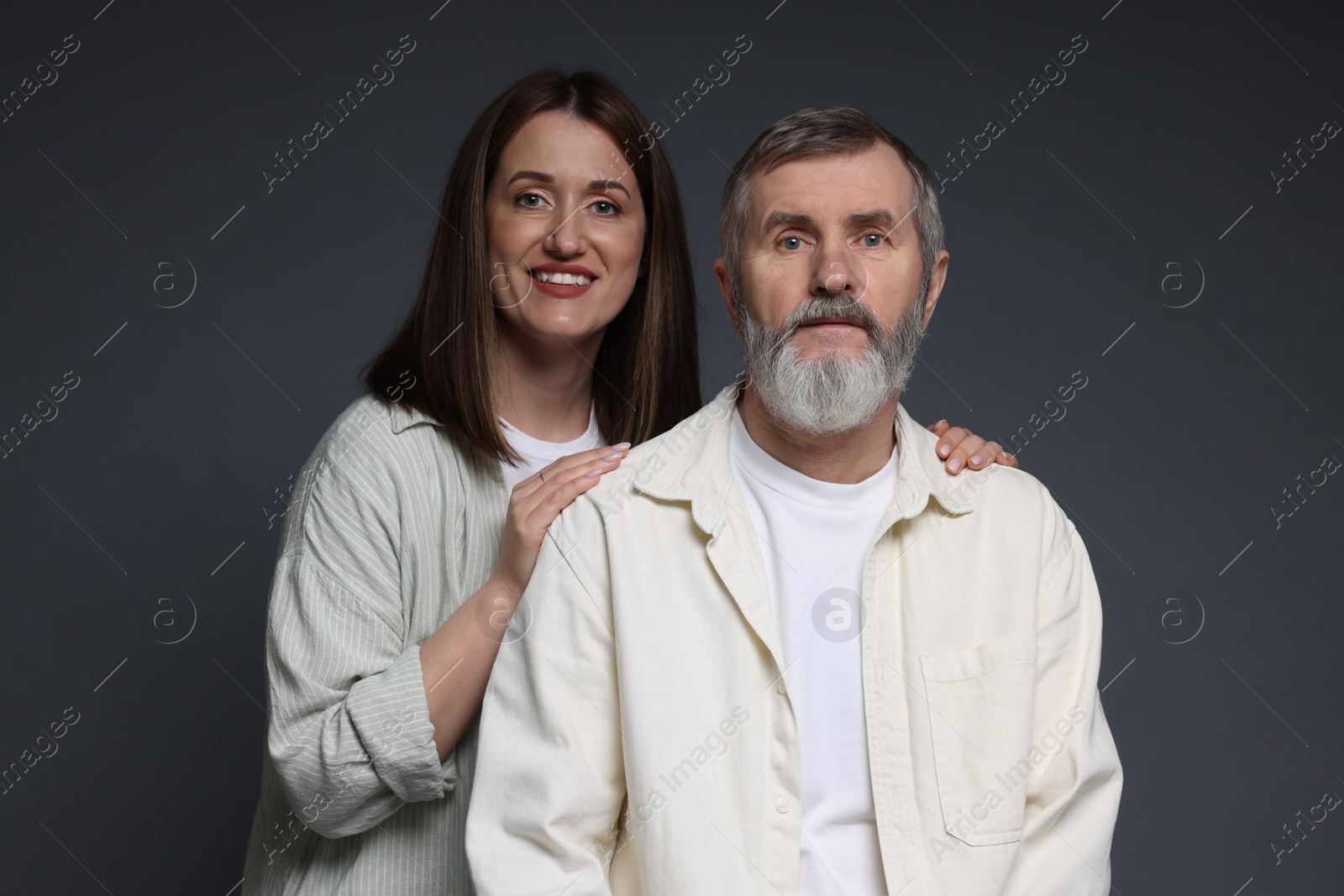 Photo of Family portrait of happy daughter and her father on dark background