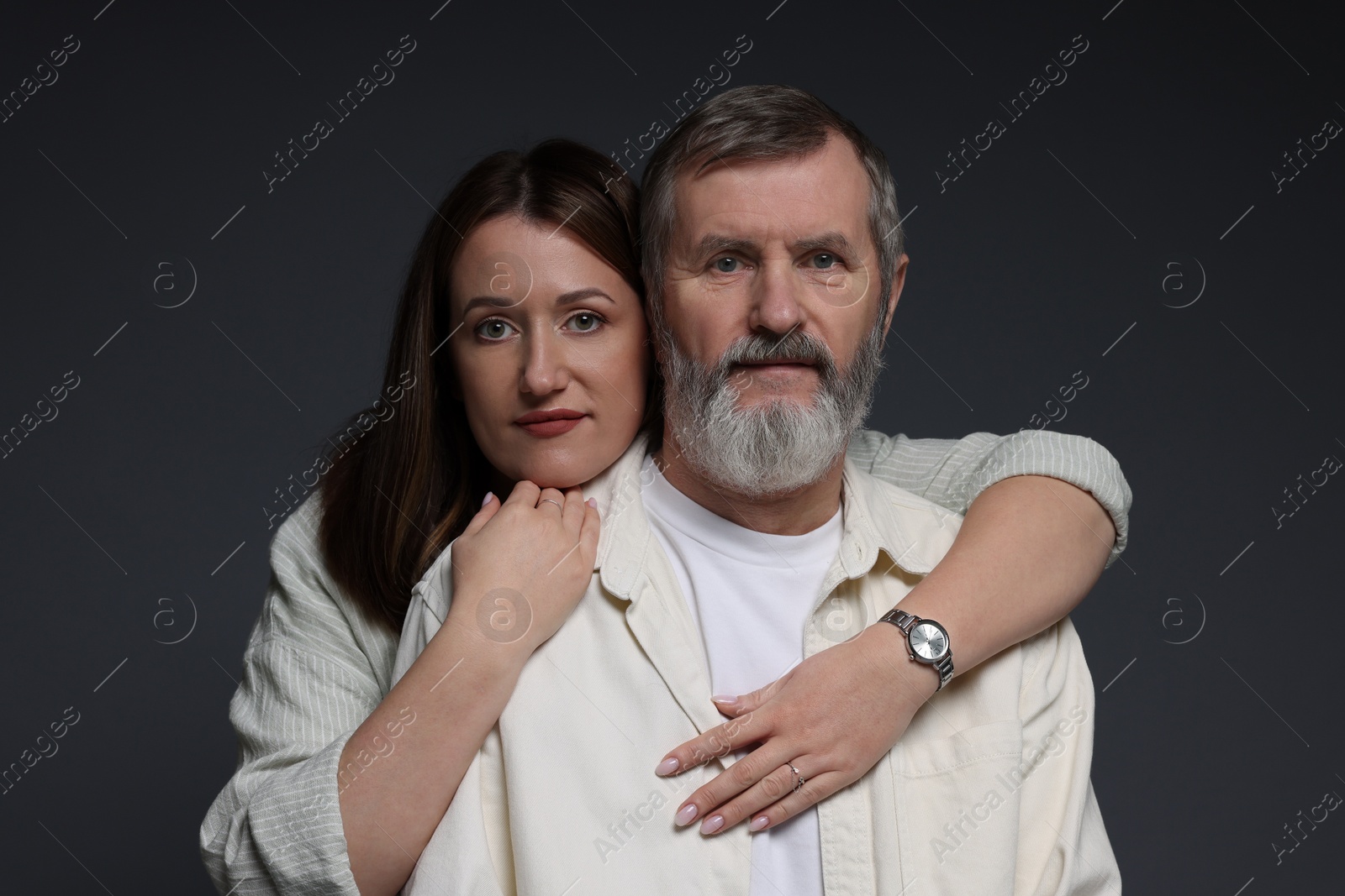 Photo of Daughter hugging her father on dark background