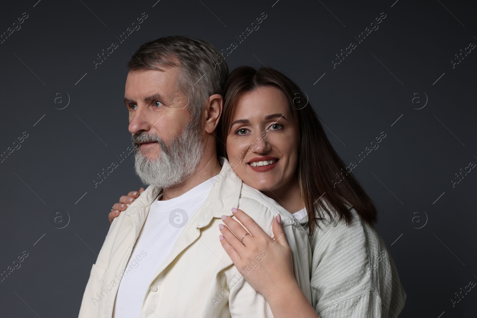 Photo of Happy daughter and her father on dark background