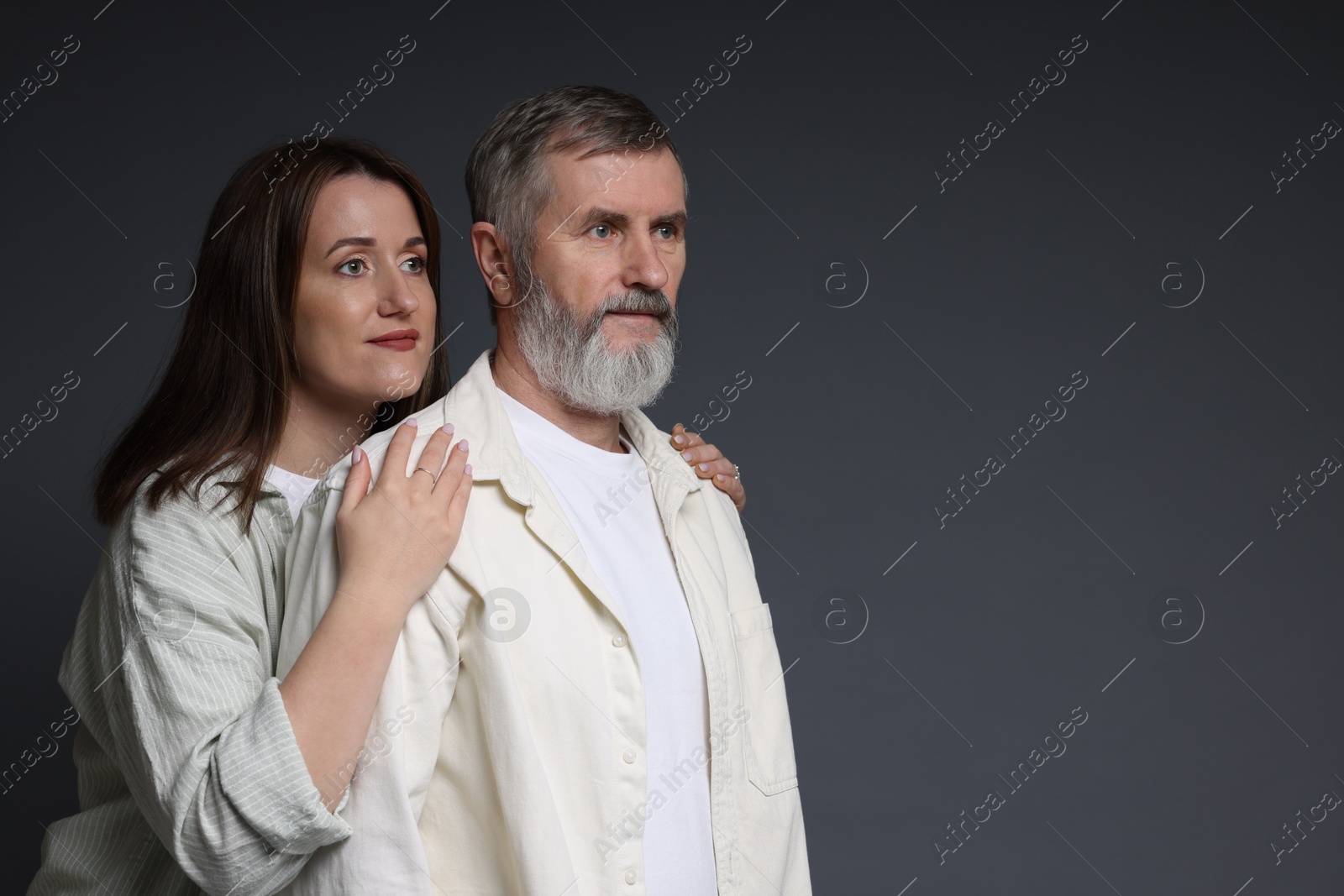 Photo of Daughter and her father on dark background, space for text