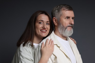 Photo of Happy daughter and her father on dark background