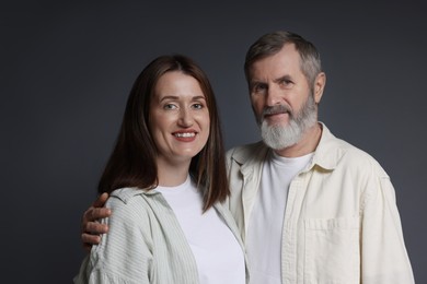 Photo of Family portrait of happy daughter and her father on dark background