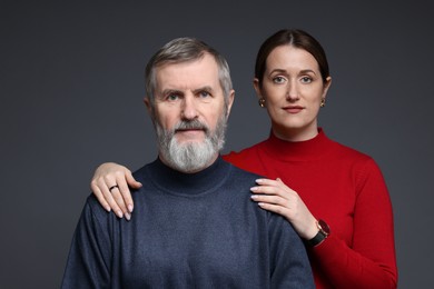 Family portrait of daughter and her father on dark background