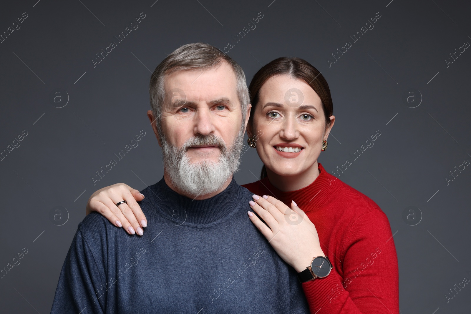 Photo of Family portrait of happy daughter and her father on dark background