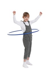 Photo of Cute little girl exercising with hula hoop on white background