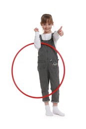 Photo of Cute little girl with hula hoop showing thumbs up on white background