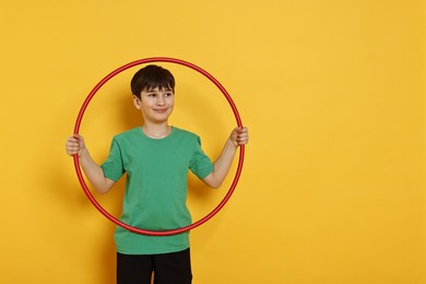 Photo of Boy with hula hoop on yellow background, space for text