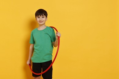 Photo of Boy with hula hoop on yellow background, space for text