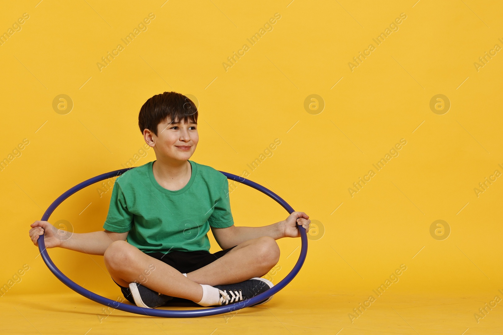 Photo of Boy with hula hoop on yellow background, space for text