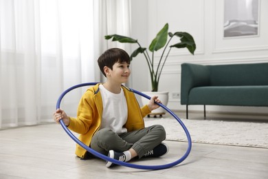 Photo of Boy with hula hoop on floor at home