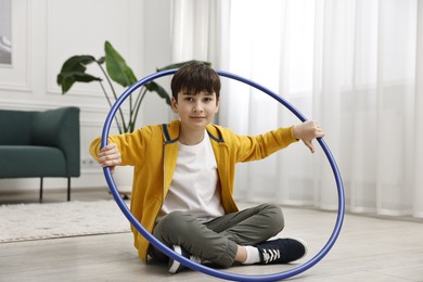 Photo of Boy with hula hoop on floor at home