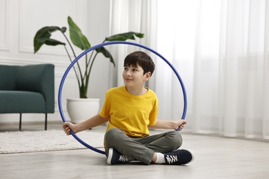 Photo of Boy with hula hoop on floor at home