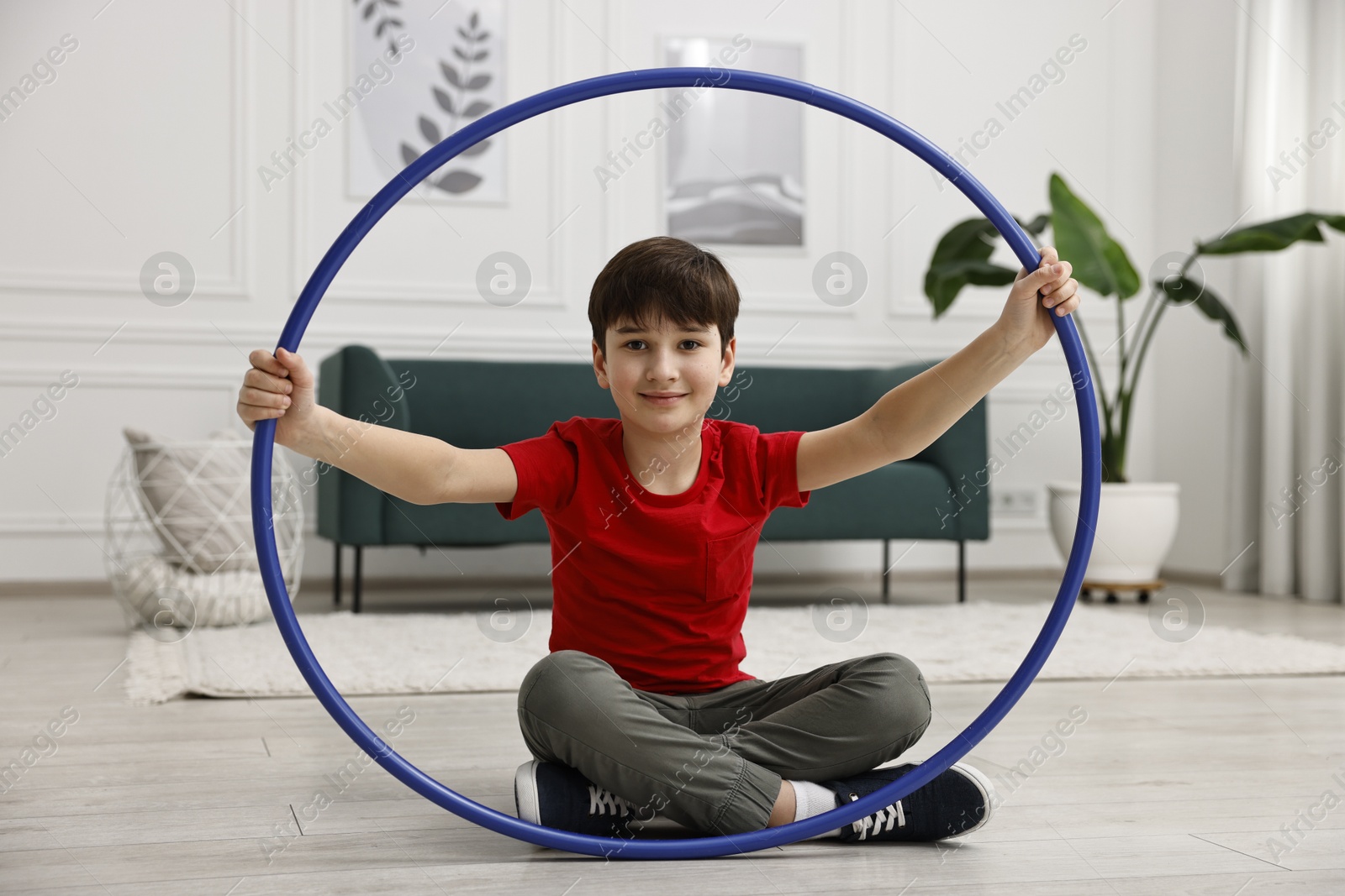 Photo of Boy with hula hoop on floor at home