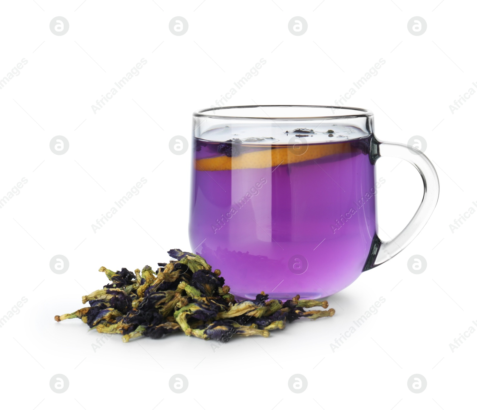 Photo of Delicious butterfly pea flower tea with lemon in glass cup and dry petals isolated on white