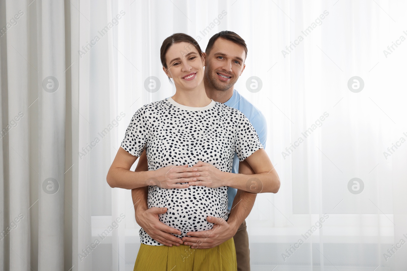 Photo of Pregnant woman and her husband at home