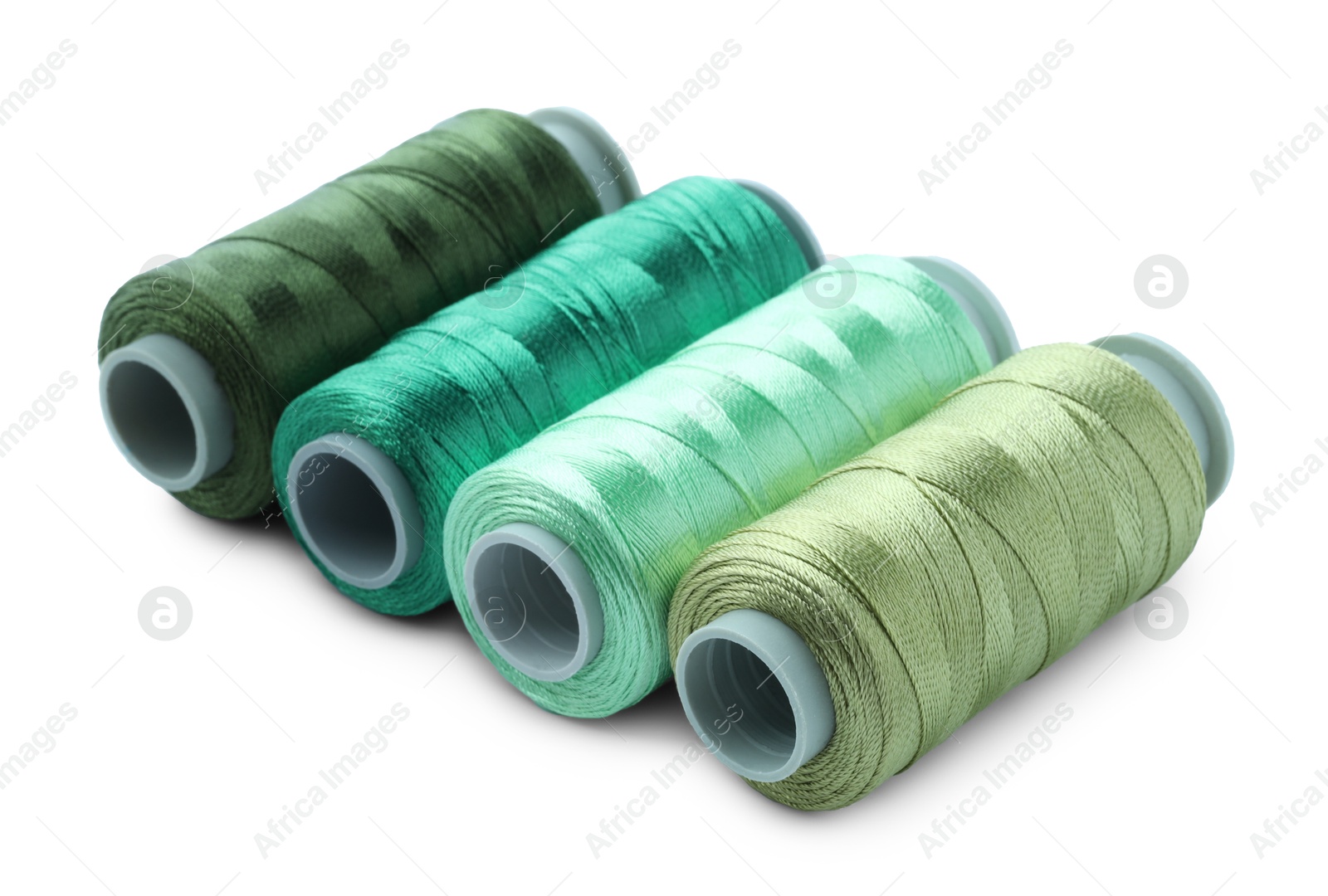 Photo of Spools of colorful sewing threads isolated on white