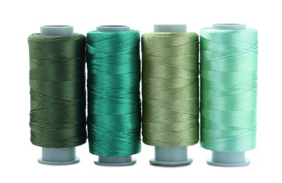 Photo of Spools of colorful sewing threads isolated on white