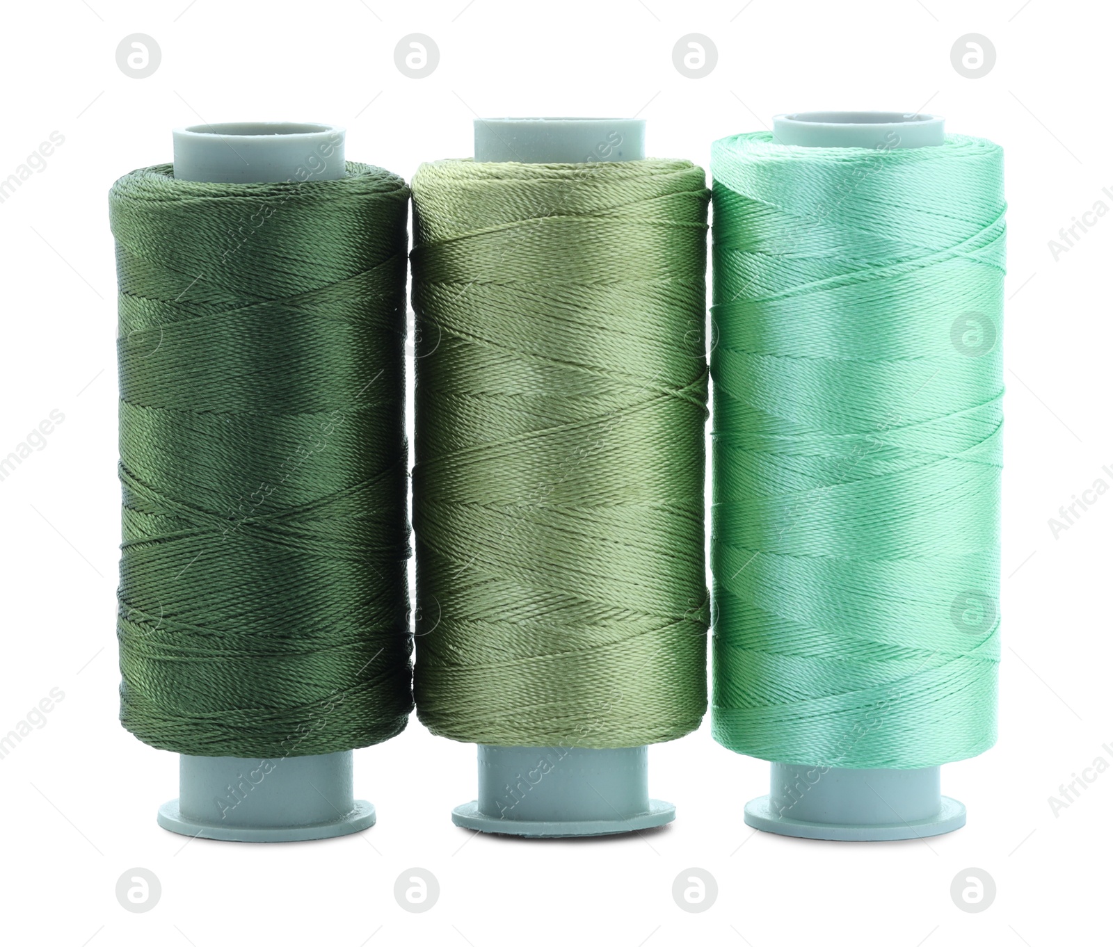 Photo of Spools of colorful sewing threads isolated on white