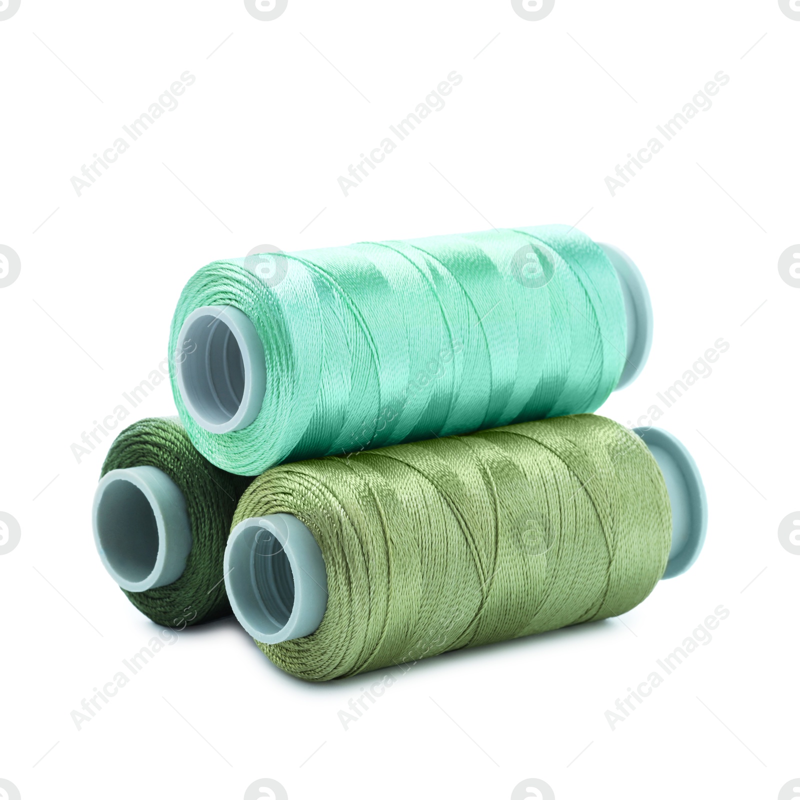 Photo of Spools of colorful sewing threads isolated on white