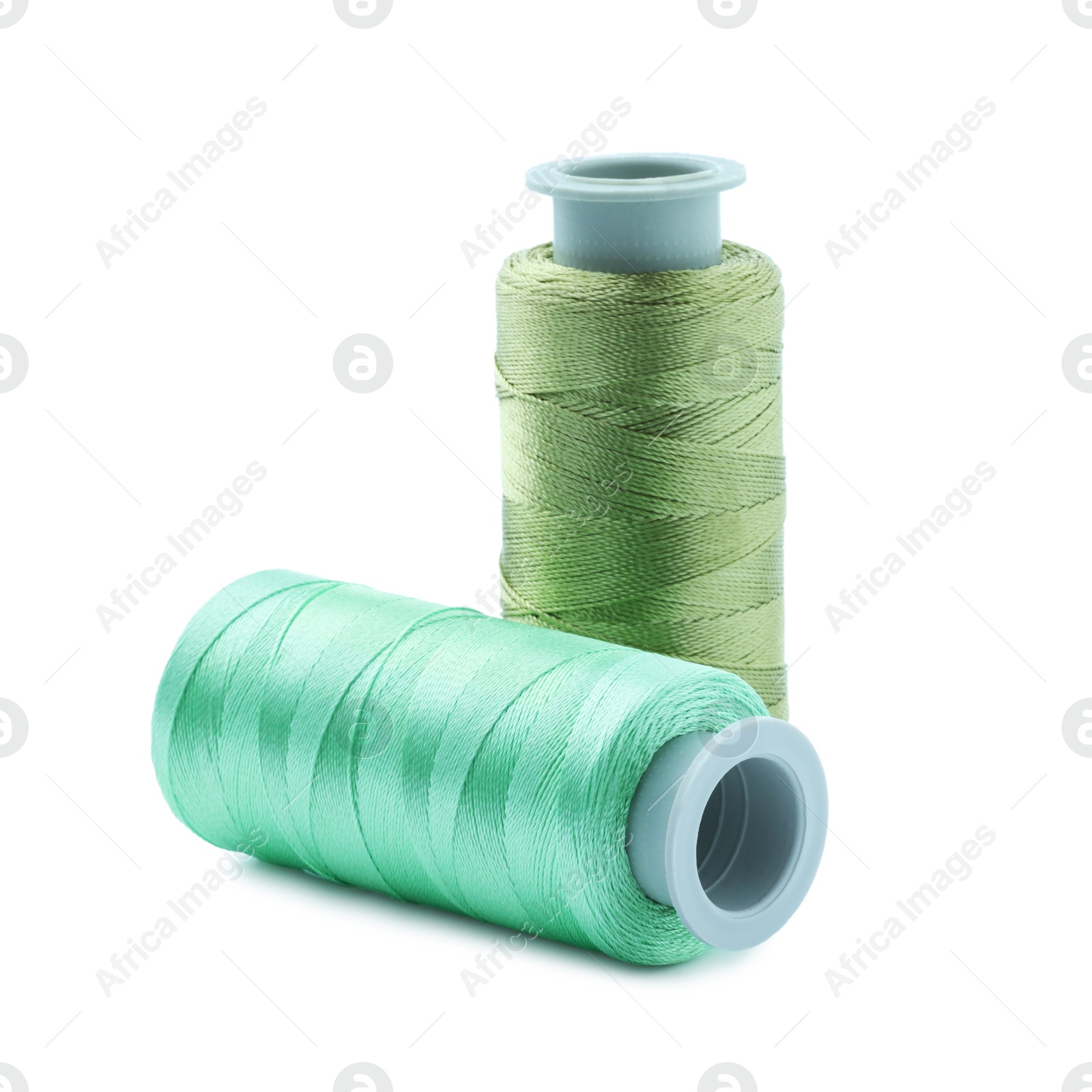 Photo of Spools of colorful sewing threads isolated on white