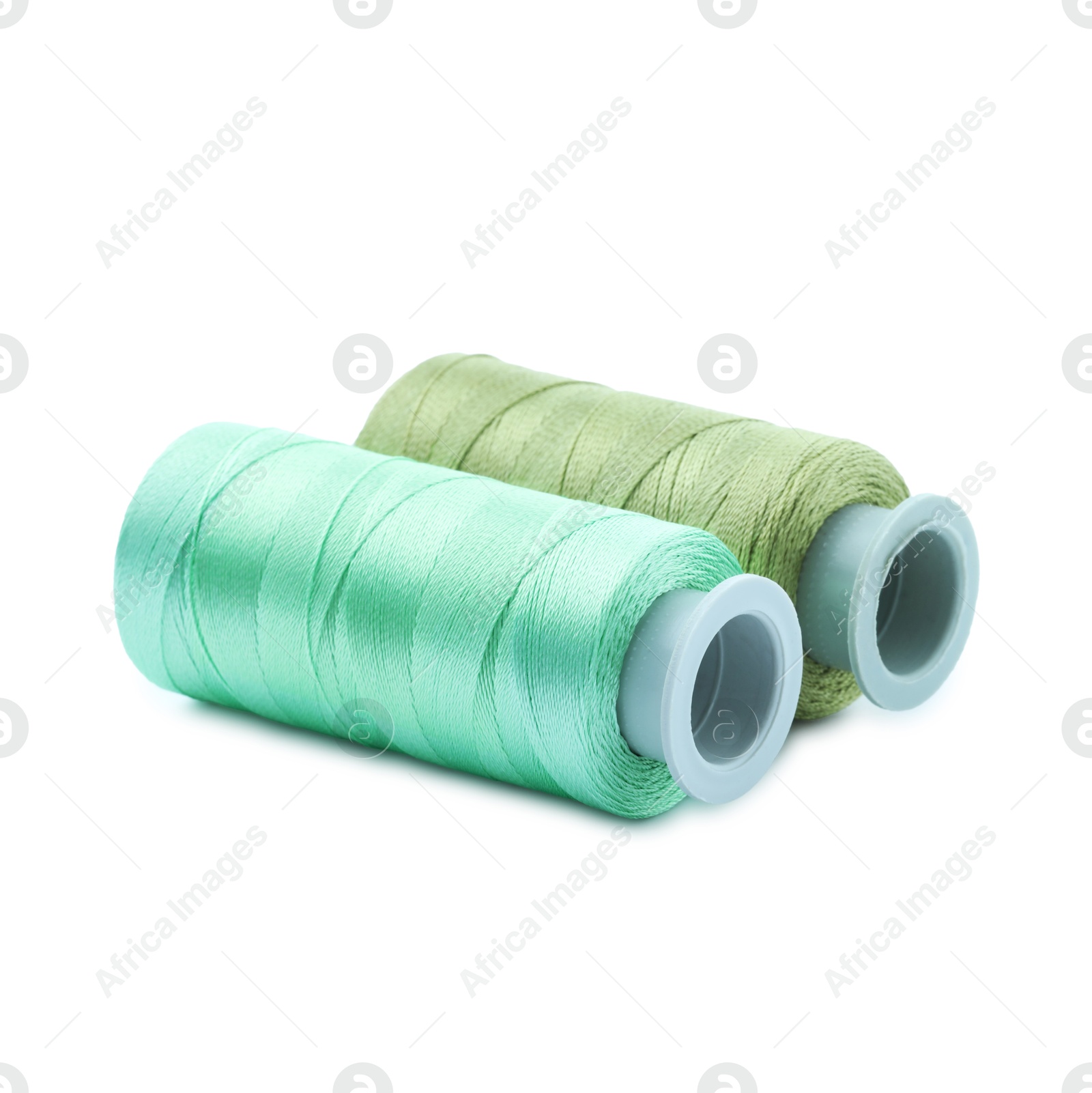 Photo of Spools of colorful sewing threads isolated on white