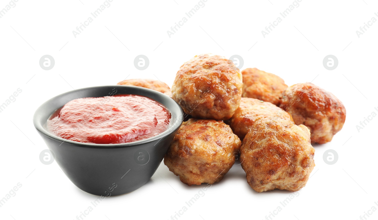 Photo of Pile of delicious meatballs and bowl with ketchup isolated on white