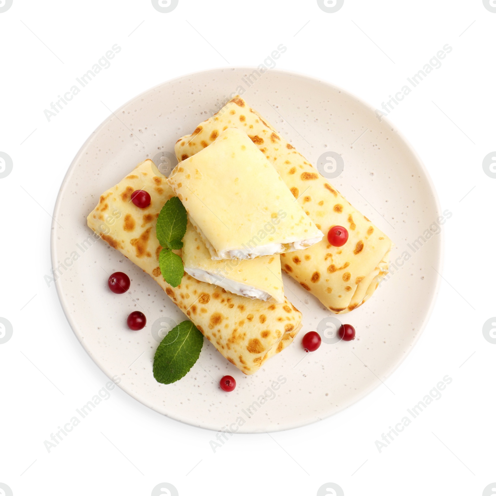 Photo of Delicious rolled crepes with cottage cheese, raisins, cranberries and mint isolated on white, top view