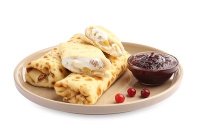 Photo of Delicious rolled crepes with cottage cheese, raisins, jam and cranberries isolated on white