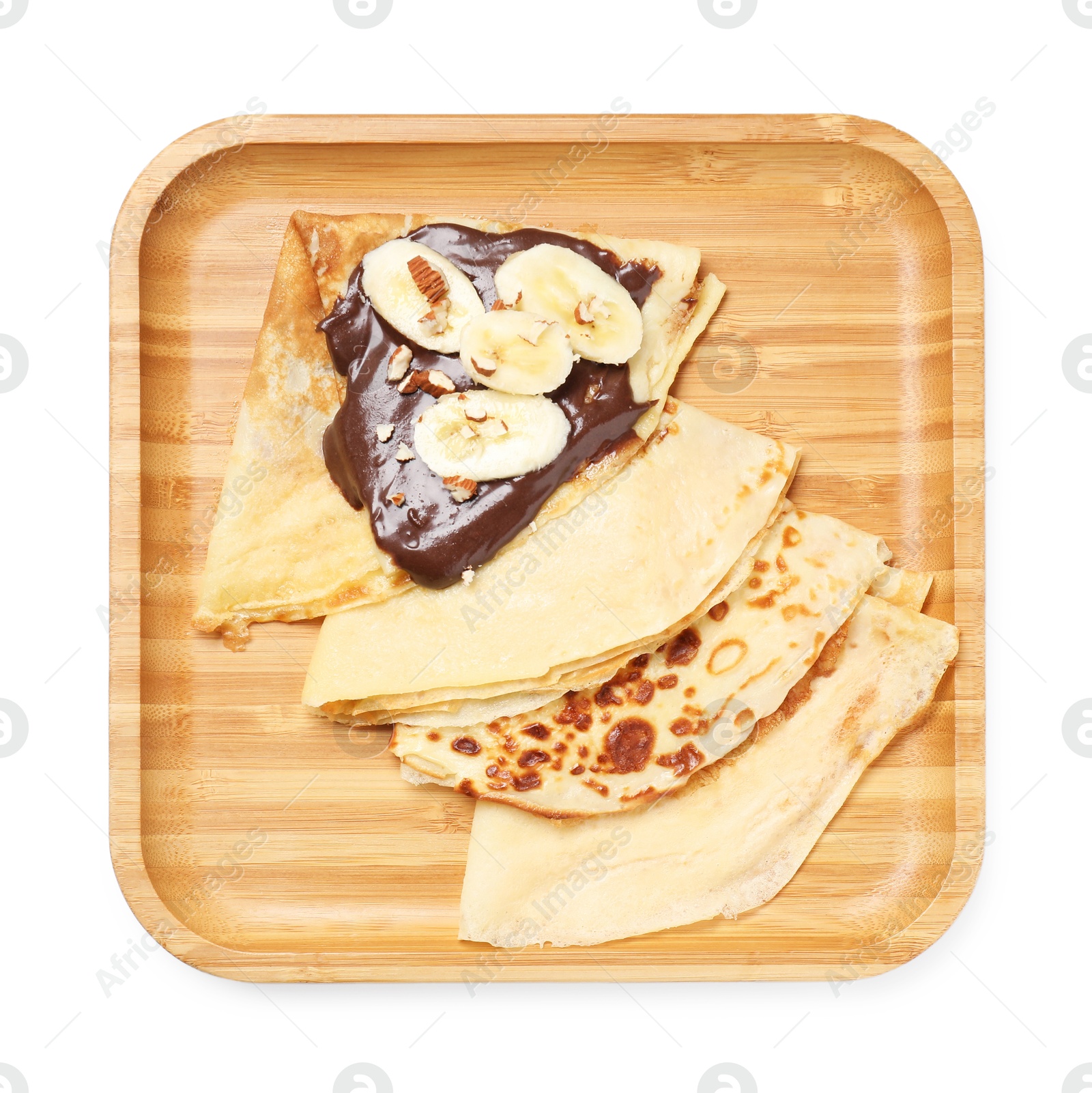 Photo of Delicious crepes with chocolate sauce, banana and almonds isolated on white, top view