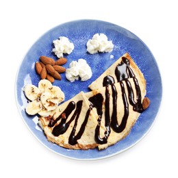 Delicious crepes with chocolate sauce, banana, almonds and whipped cream isolated on white, top view