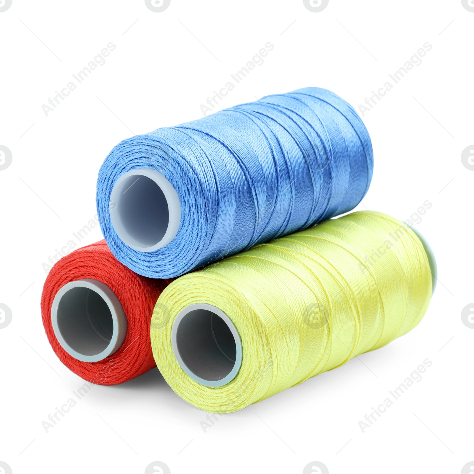 Photo of Spools of bright sewing threads isolated on white