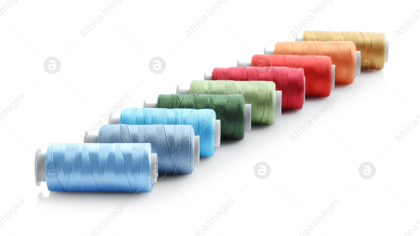 Photo of Spools of bright sewing threads isolated on white