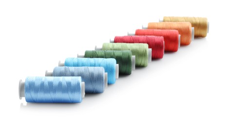 Photo of Spools of bright sewing threads isolated on white