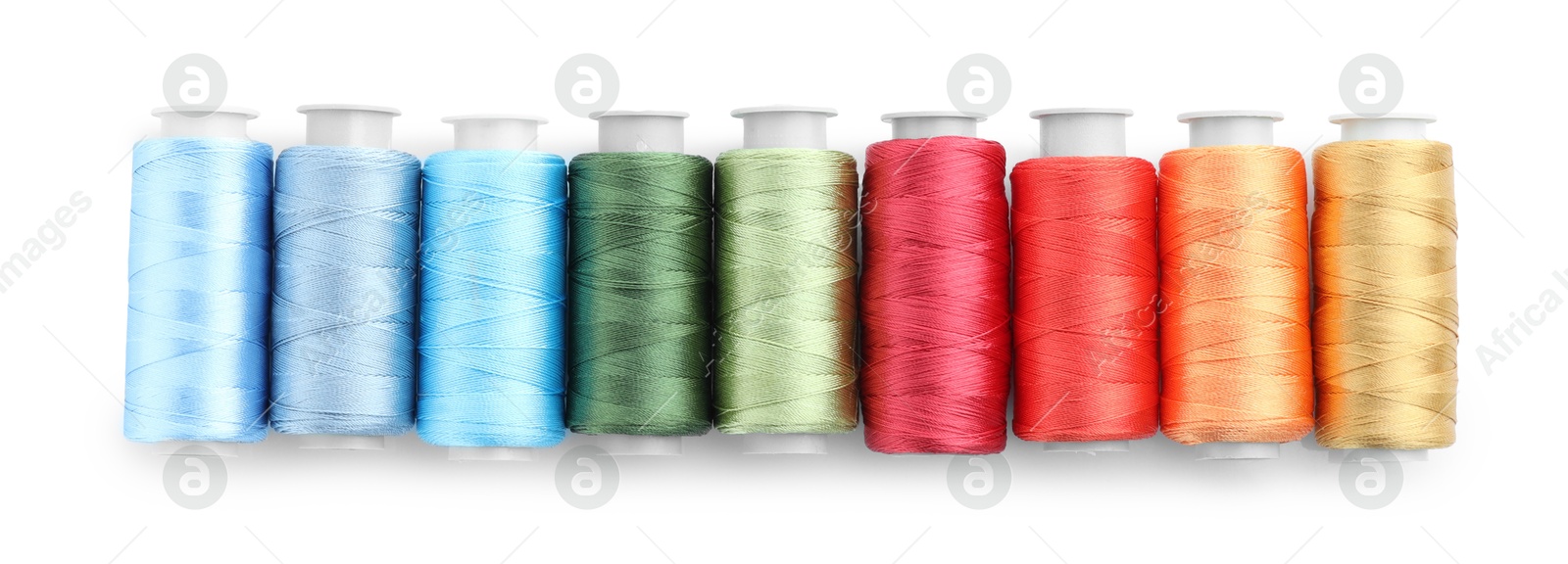 Photo of Spools of bright sewing threads isolated on white, top view