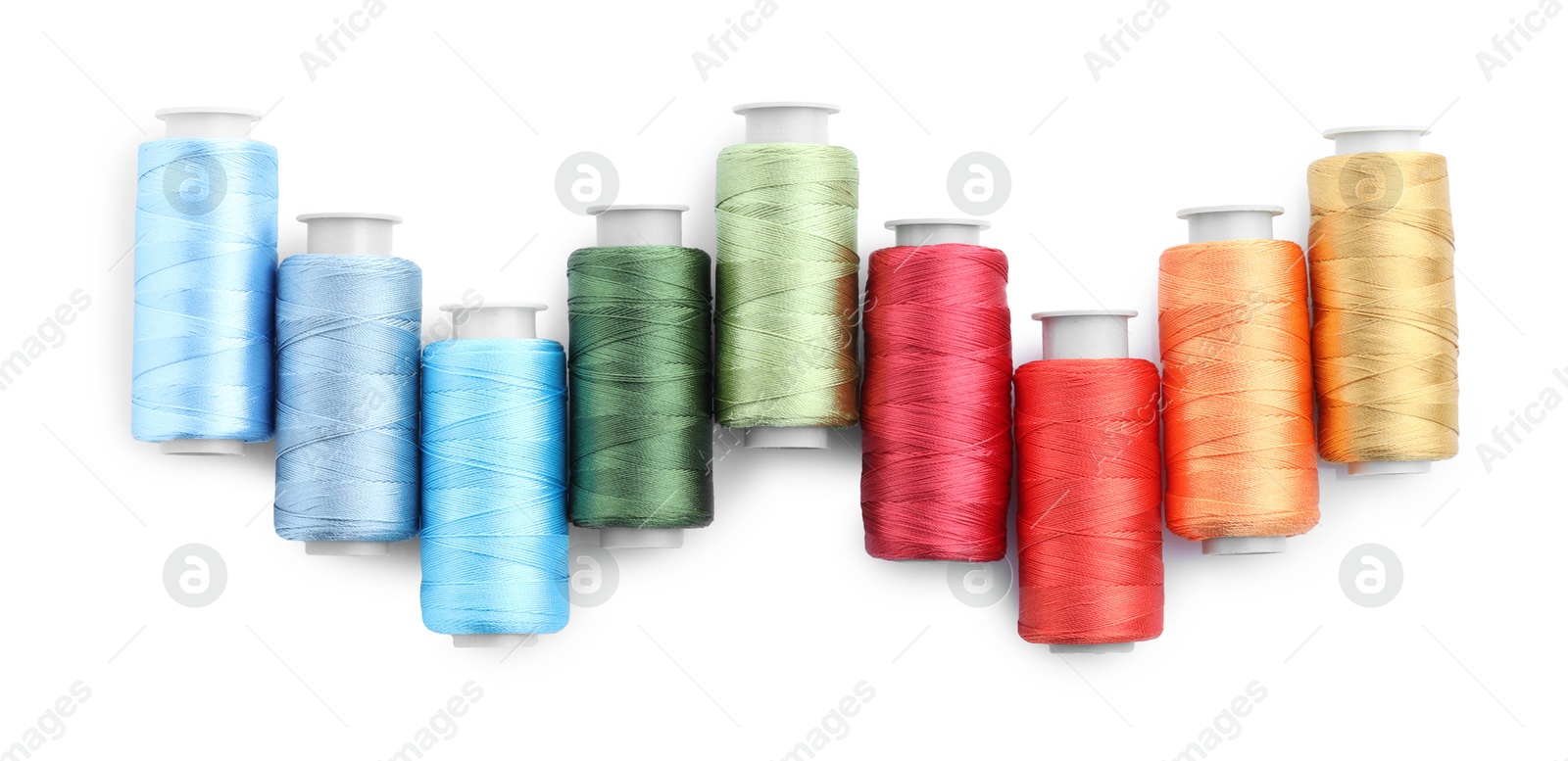 Photo of Spools of bright sewing threads isolated on white, top view