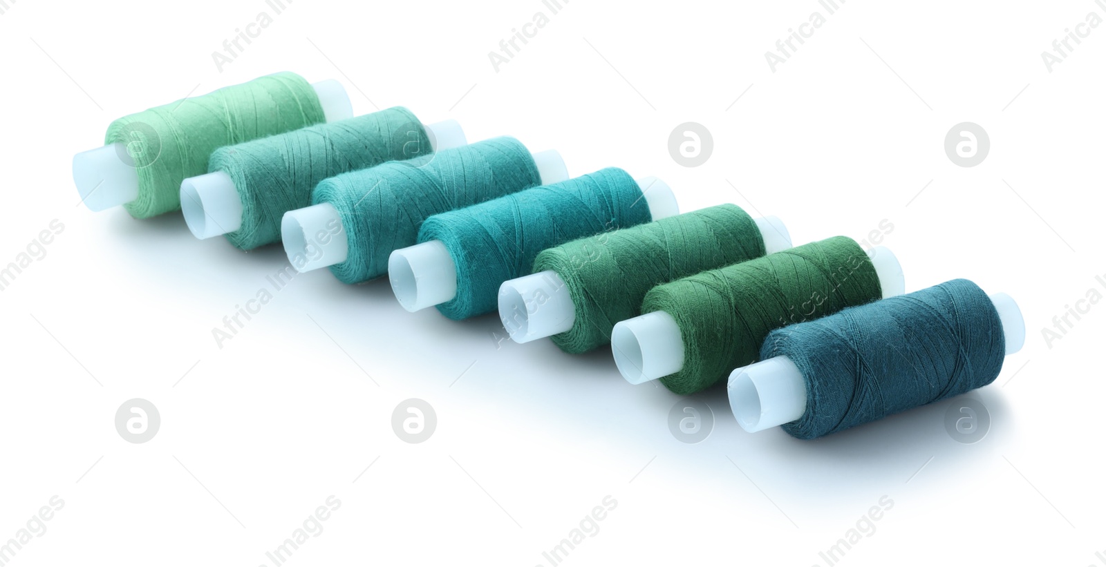 Photo of Spools of bright sewing threads isolated on white