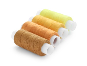 Photo of Spools of bright sewing threads isolated on white