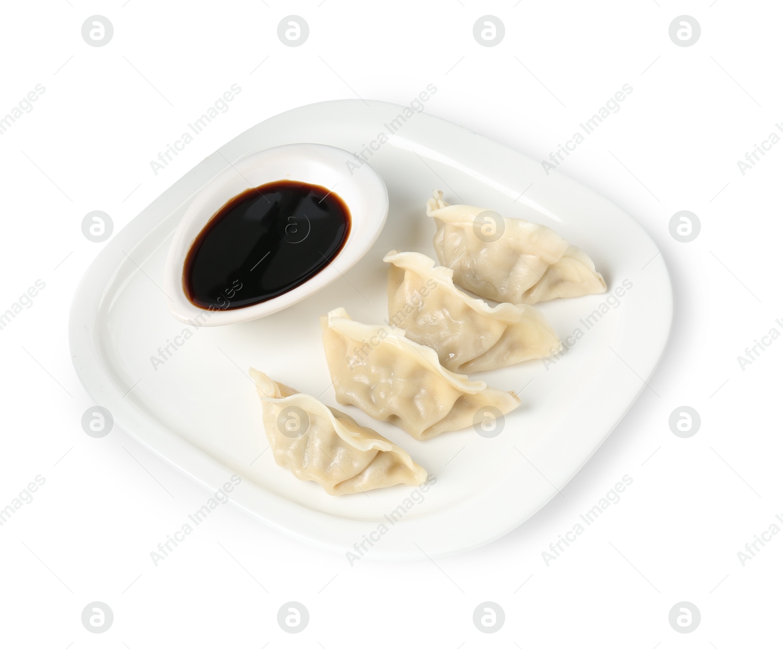 Photo of Tasty gyoza (dumplings) and soy sauce isolated on white