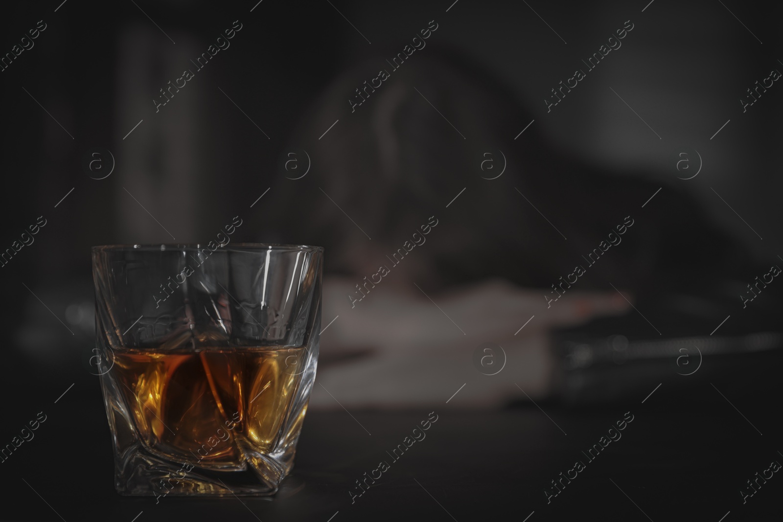 Image of Alcohol addiction. Drunk woman, focus on glass of whiskey